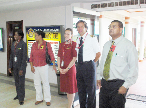 Captain Thomas Kluge (second from right) minutes after touching down in Guyana and two flight attendants chatting with Director of Tourism, Ministry of Tourism, Indranauth Haralsingh (right) and Director of THAG, Renata Chuck-A-Sang (second from left). 