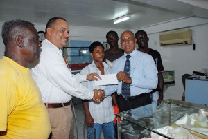 President of the Guyana Amateur Boxing Association (GABA) Affeeze Khan (front right) receives the donation valued at $100,000 from Managing Director of Gaskin and Jackson Jewellers, Dean Jackson (second left). (Clairmonte Marcus photo)