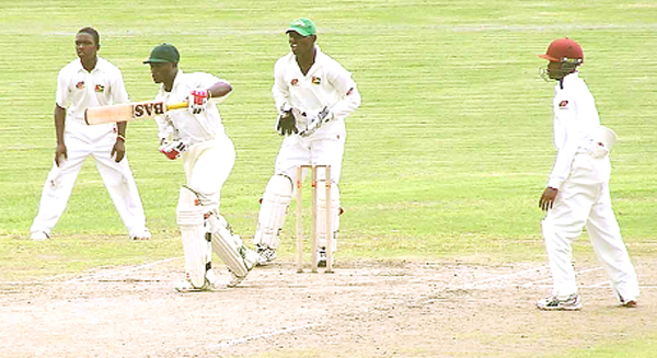 Jamaica’s captain Andre Creary plays a drive off the bowling of Herman Latcha (not in picture) during his innings of 118 as from left Eugene La Fleur, wicketkeeper Anthony Bramble and Trevon Griffith looks on. 