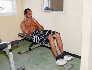Michael De Mattos doing sit-ups at the Andrew “Sixhead” Lewis gym in Albouystown as he prepares to take on Joel Mc Rae on Saturday at the Cliff Anderson Sports Hall. (Clairmonte Marcus photo)