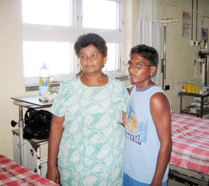 Munesh Mangal and his mother at the Georgetown Public Hospital prior to the surgery on Friday. (Photo courtesy of the Ministry of Health)