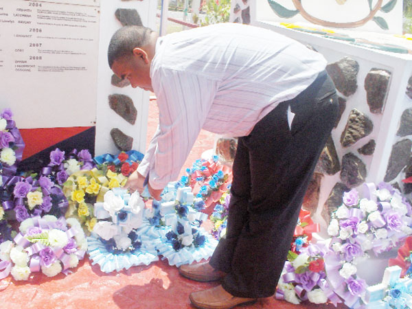 Trivon Willie, the brother of Constable Ron Osborne lays a wreath in his memory at the ceremony at the Police Office’s Mess, Eve Leary yesterday. 
