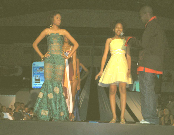 Winner Sharda Elegon wearing one of her won designs (centre) speaks to host Stan Gouveia. At left is a model wearing another of her designs.