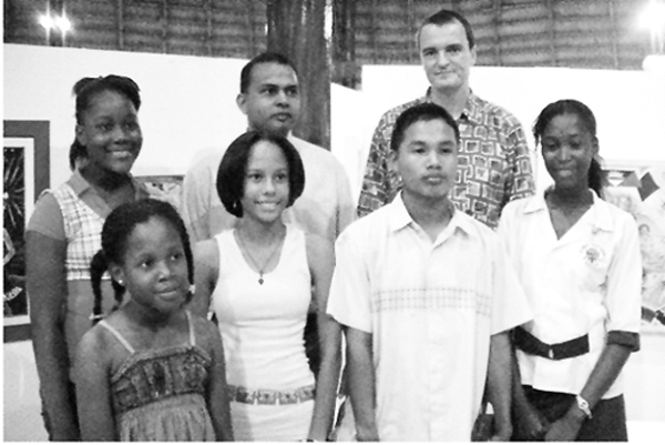 Culture Minister Dr Frank Anthony, second, back row and UNICEF Representative Johannes Wedenig, third, back row pose with the winners in the Carifesta Child Art Competition. 