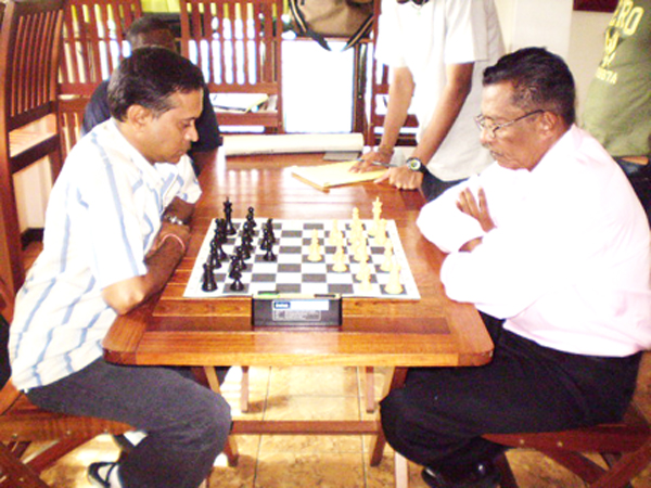 Nandalall (left) and Tiwari at work during the final game of the Oasis knockout chess tournament
