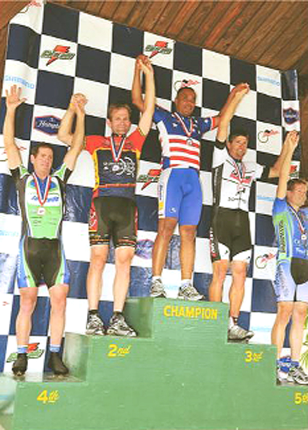 Guyana’s US-based cyclist Aubrey Gordon(centre) mounts the podium at the recent US Masters National Championships.