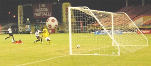 GOLDEN CUB! Debutant Glenorvan Edmonds ($18) pats the ball into the open net to score Guyana’s second goal against Dominica in the Group B match of the Digicel Caribbean Cup tournament at the National Stadium at Providence yesterday. (Lawrence Fanfair photo)