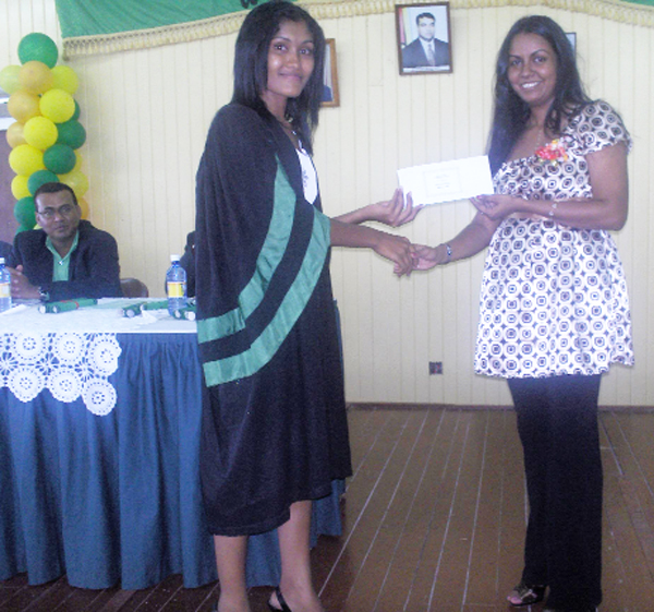 Best graduating student, Vanita Ramnarain (left) collects the Principal’s prize from Kamini Persaud, wife of Agriculture Minister Robert Persaud.  