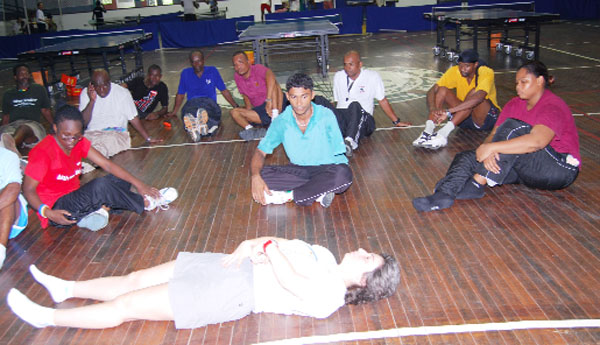  Gabaglio, (right) , takes the participants through some stretching exercises yesterday. (Lawrence Fanfair photo)