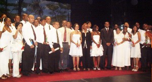 Some of the graduates pose with President Bharrat Jagdeo (right, in suit) at the National Cultural Centre yesterday.  