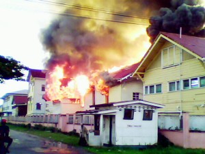 The fire at the Georgetown Hospital Observation Ward shortly after it began yesterday morning. The entire block was engulfed in flames about 15 minutes after. 