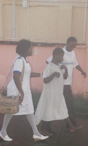 A patient being escorted to the Psychiatric Clinic by hospital staff during the fire yesterday. (Jules Gibson photo)