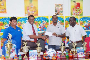 General Manager of Guyana Beverage Company Inc, Robert Selman hands over the sponsorship cheque to GFA 1st Vice President Wayne Ford while GBC Inc. Customer Representative Shameiza Yadram (L) and GFA Secretary Marlon Cole (R) look on. (Clairmonte Marcus photo).