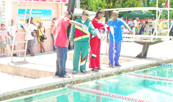 The captains of the four teams from left Suriname, Guyana, Trinidad and Barbados symbolically pour water into the pool to begin the 2008 Goodwill championships at the Castellani  pool yesterday