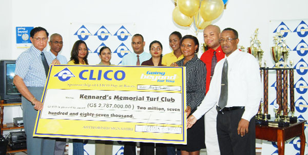 Sales and Marketing Manager of CLICO Guyana Ltd., Venita Bovell, third right, hands over the cheque for $2.7m to honorary president of the Kennard Memorial Turf Club and retired Chancellor of the Judiciary, Cecil Kennard, right. (Lawrence Fanfair photo)