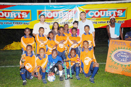 In this Clairmonte Marcus photo,  the successful Fruta Conquerors team  strike a pose with executives of furniture giants Courts (Guyana) Limited. At left front row is tournament MVP Ryan Hackett.