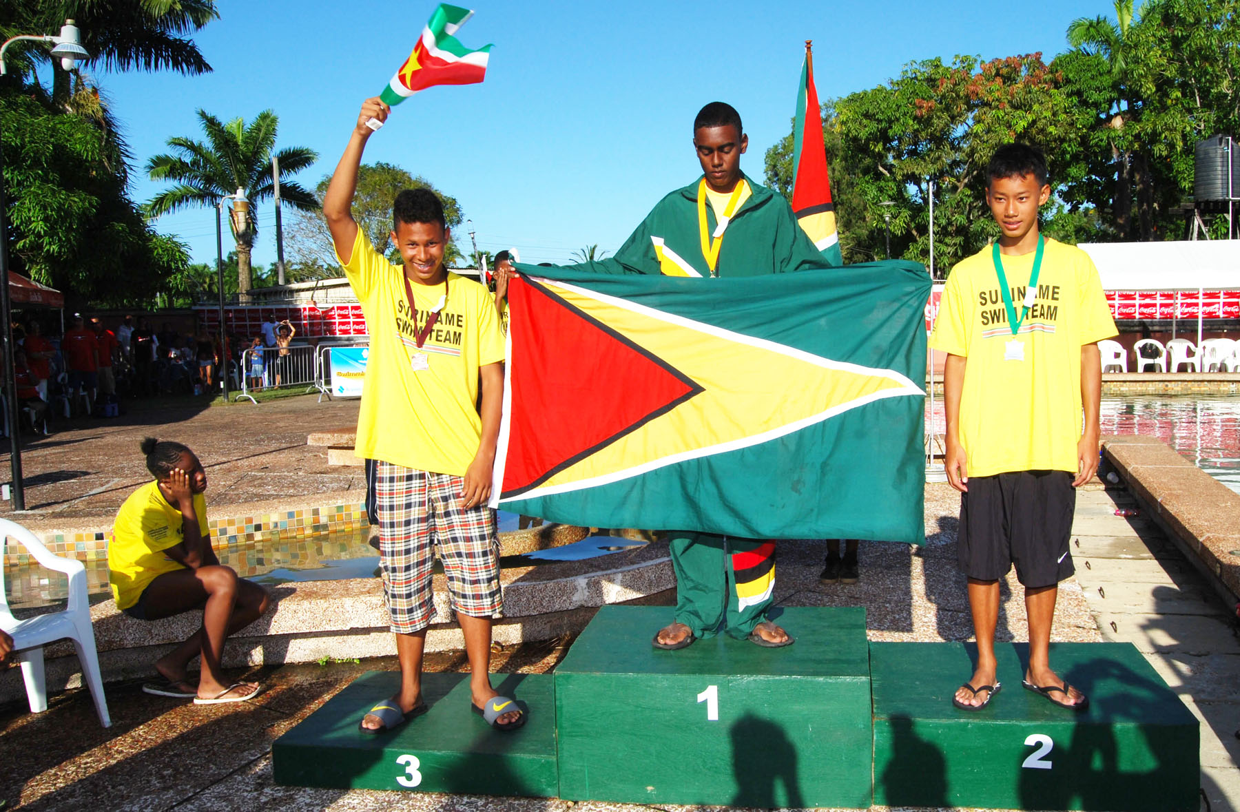GOLDEN BOY! Guyana’s Linden Wickham (center) came up short at Carifta this year but did not disappoint at home in this year’s Goodwill Championships. Wickham emerged as the only male gold medalist after wining the 50m freestyle event ahead of Suriname’s Bjorn Lie Kwie (right) and Kevin Panoet . (Lawrence Fanfair photograph)  