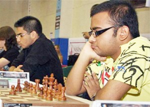 The Indians are coming! World Junior Champion Abhijeet Gupta at the chessboard on the right. Next to him is 15-year-old grandmaster Parimarjan Negi, who took the silver medal in the World Junior Championship held recently in Turkey. 