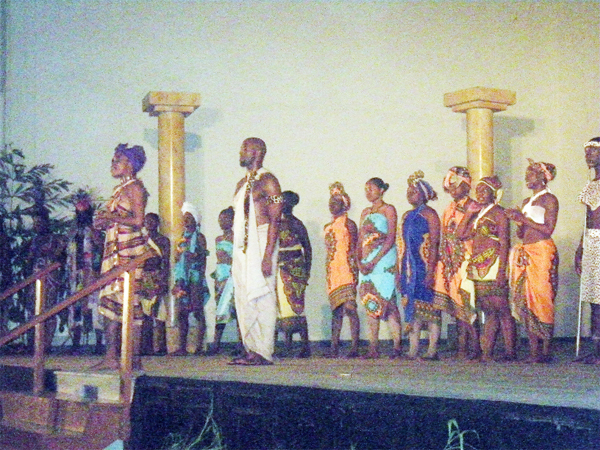 Part of the cast of Odale’s Choice, in the foreground is  Rashida Harding (left) (Odale) and John Hunte (right) (Creon).