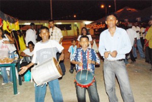 These young men moved through the crowd at Bhajan Deepanjali at the National Stadium, Provi-dence on Wednesday night spreading the lively beats of the Indian Tassa and Nagara drums.