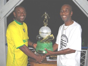 Pele captain Dennis Chow Hunt (L) receives the ‘Breezer, Nedd Memorial  trophy from Courtney Feff Fanfair (R) on Sunday evening at the GFC ground, Bourda.