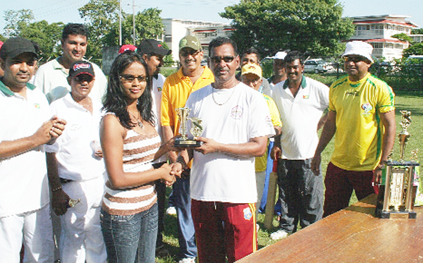 Floodlights XI Ramesh Sunich receives his Man-of-the-Match trophy from Shivanie Latchman of Saravin Sawmill Limited.