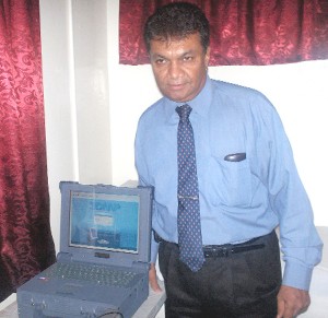 Dr Errol Basso stands next to the 3DMP machine at his New Market Street laboratory.