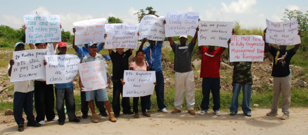 Workers from Mabura Hill protest outside the Demerara Timbers office in Kingston. (Photo by Jules Gibson)