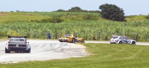 Stuart Williams being pursued by Guyana’s racing driver Andrew King with Barbados’s  Stuart Maloney in close pursuit at the Bushy Park Circuit in Barbados during the second leg of the Caribbean Motor Racing Championships.