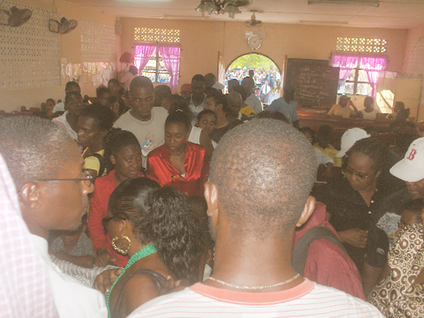 Villagers viewing ‘Skinny’s’ body in the church following the funeral service yesterday.