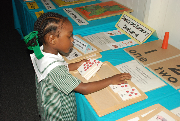 This little one from Starters Nursery School was caught putting her counting skills to the test at the exhibition of teaching and learning materials hosted by the Ministry of Education last week. (A Jules Gibson Photo) 