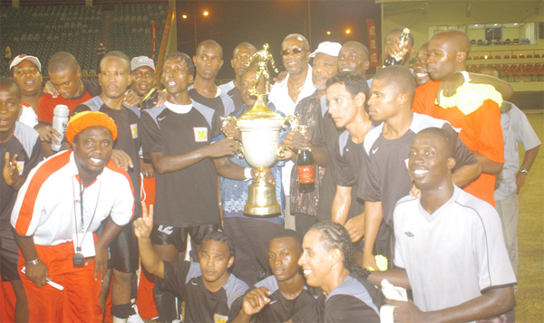 The victorious Alpha United football team celebrate yet another tournament triumph. (Aubrey Crawford trophy)
