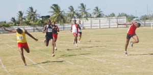 Close Shave!!! Running Brave’s Ian Campbell (far left) just edges out Police Sports Club’s Patrick King (R) in the Junior Male 200m while Ruralites’ Alton Seaforth (2nd L) finishes third at the Enmore Sports Club ground on Sunday.  