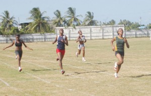 Police Sports Club’s Letitia Myles (R) wins the Girls’ Under-18 200m ahead of her running mates Ianna Graham (2nd L), Tiffany Carto (L) and Upper Demerara’s Keyandra Zephyr at the National Youth/Junior Championships at the Enmore Sports Club ground on Sunday.  