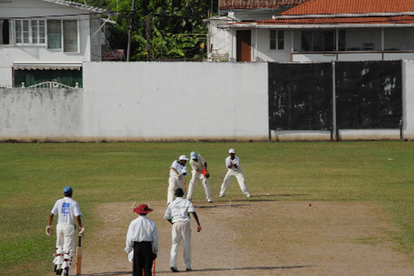 Dayanand Roopnarine plays a square cut off the bowling of Trinson Carmichael during his innings of 77, as Dellon Fernandes (non- striker), Andy Mohan (wicket keeper) and Harrinarine Chattergoon (first slip) look on. (Clairmonte Marcus photo)         