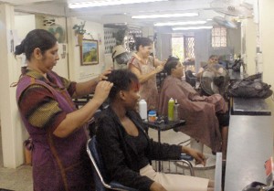 Stylists Guytria (left) and Rose (right) attend to customers.