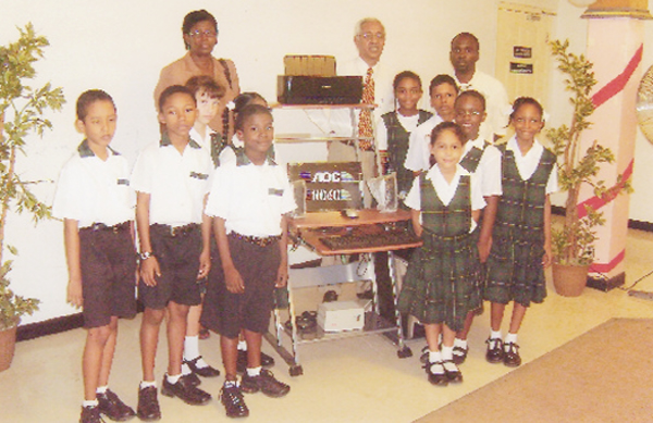 The presentation for the Fogarty’s Back to School Promotion took place on Thursday.  The promotion which started on July 8 enabled students, parents and teachers to enter with purchases of $2,000 and more at any of the stores. The top prize of a complete computer system and workstation went to Mayglen Charles, Headmistress of Mae’s Primary. The $25,000 gift certificate went to Ashley Peroune of Marian Academy, the $15,000 certificate to Sara Shuffler of St Mary’s Primary and the $10,000 certificate to Deepa Premraj of Covent Garden Primary. Thirty-two other prizes were awarded.  In photo Executive Director Vibert Parvatan (standing second from right in back row) poses with Mae’s Headmistress, Mayglen Charles (standing at back) with children of the school.  