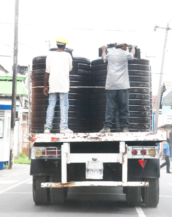 Life on the edge: These two men were standing on the edge of this truck tray yesterday.  
