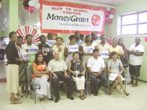 The contest winners pose with Neal and Massy CEO Deo Persaud (sitting second from left) and other company officials. 