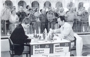 Topalov faces Carlsen as spectators view the game through the glass wall