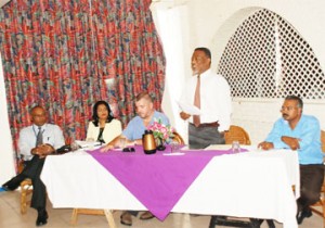 Prime Minister Sam Hinds (standing) making brief remarks at the Amaila Fall Hydro Electric Power project meeting. From left are GPL General Manager Bharrat Dindyal, legal advisor attached to NICIL Marcia Nadir-Sharma, Christopher Kelly of Sithe Global Power, and President of Synergy Holdings Inc Makeshwar Fip Motilall. (Photo by Jules Gibson)    