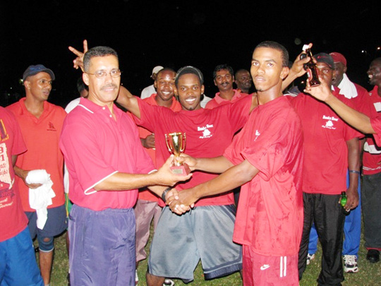 Jermaine Martins receives the man of the match trophy from Andre Farinha, left.