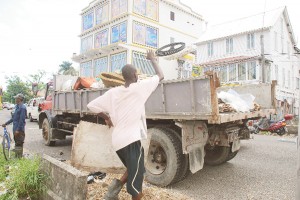 The truck that carted off Brian Walrond’s “home” being loaded up yesterday. (Photo by Jules Gibson)