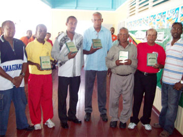 Members only! Vice-presidents of the Berbice Cricket Board of Control (BCBC) Keith Foster, David Black (left and second left respectively) and Mark Lyte (right) flank the awardees Carl Moore (third from left), Mortimer George, Seelochand Singh and Rafik Latiff.   