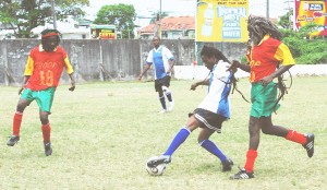 Terry Simpson of Hearts of Oak controls the ball in midfield while being challenged from a Rastafari Patriarch player. (Lawrence Fanfair photo)   