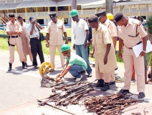 Officers of the Guyana Police Force looked on as some of the old weapons were being disassembled and destroyed yesterday.  
