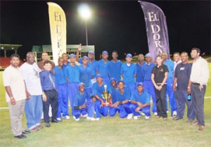 CHAMPIONS AGAIN! Demerara Cricket Board (DCB) executives including president Bissoondial Singh (third from left) strike a pose with the victorious senior Demerara Inter-County team after they defeated Berbice by 71 runs at the Guyana National Stadium, Providence Friday night. (A Lawrence Fanfair photograph). 