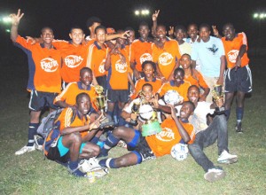 The victorious Fruta Conquerors football team celebrate their win. (Clairmonte Marcus photo).   