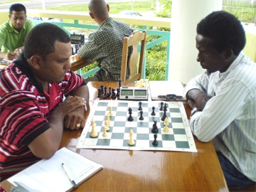 Kriskal Persaud, national Chess champion contemplates a move against Learie Webster.
