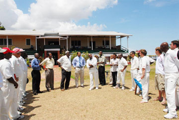Minister of Culture, Youth and Sport Dr. Frank Anthony (centre) flanked by Director of Sport, Neil Kumar, sixth left, PS Keith Booker, fifth left and English captain Monty Lynch.      